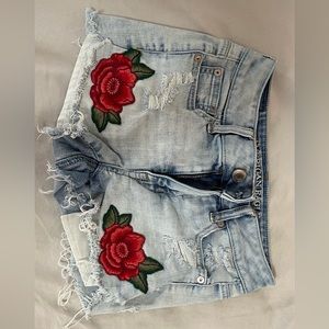 American eagle Jean shorts with roses on each leg size 0